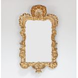 A George II giltwood mirror, the frame with pierced and carved open shell surmount with borders of C