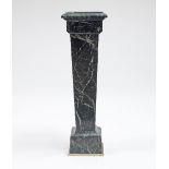 A variegated green and white veined marble column of Classical design,