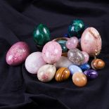A collection of eighteen mineral eggs including rose quartz, lapis lazuli, malachite, tiger's eye,