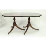 A 20th Century mahogany two-pillar dining table with two leaves,