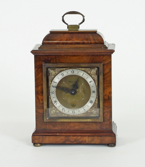 An Elliot walnut cased mantel clock, retailed by Camerer Cuss & Co, London, stamped beneath 2823,