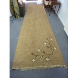 An Egyptian camel wool runner, 1956, with leaf design to one end, 500cm x 130cm Condition Report: