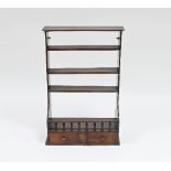 A 19th Century walnut rack of shelves with galleried bottom shelves and two drawers beneath,