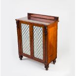 A Regency mahogany cupboard, the back with knulled border and flowerheads to each end,