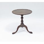 An 18th Century circular mahogany table on a turned column and tripod support with pad feet,