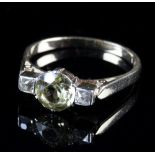 A zircon and diamond three stone ring, the central pale yellow stone flanked by two diamonds,