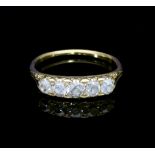 A five-stone diamond ring, in a scroll setting to a yellow metal shank,