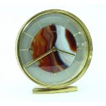A Jaeger LeCoultre desk clock, of 1970s design, the circular dial centred by a banded agate panel,