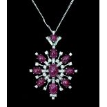 A ruby and diamond pendant of starburst form,