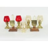 Two pairs of brass mounted oil lamps, one pair with red glass shades, 23cm high including shade,