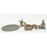 An Eastern brass figure, possibly Lakshmi seated holding a lotus flower, 24cm high,