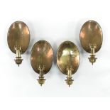 A set of four tinplate and brass wall lights, each with oval dished backs and column light fitting,