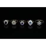 Five gem set cluster rings, each on a 9ct gold shank,