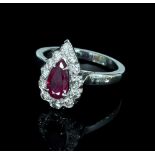 A ruby and diamond cluster ring, the pear-shaped ruby to a border of twelve diamonds,