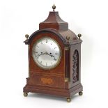 An 19th Century bracket clock, the silvered dial with Roman numerals,