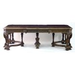 A Continental walnut centre table with carved border and canted corners,