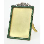 An enamelled easel back photograph frame, surmounted by a ribbon tie, to take a photograph 13.