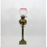 A Victorian brass oil lamp, with Corinthian column on square stepped base,