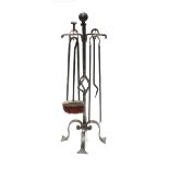 An Arts and Crafts style matched fire iron set,