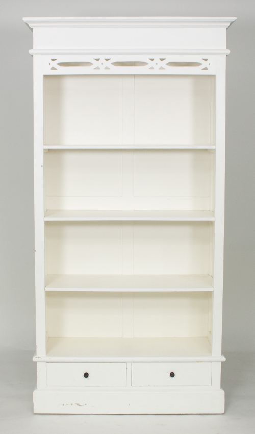 A painted open bookcase, with pierced frieze above open shelves and a drawer on a plinth base,