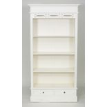 A painted open bookcase, with pierced frieze above open shelves and a drawer on a plinth base,