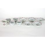 Four New Hall tea bowls, five saucers and a cream jug,