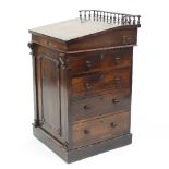 A Regency rosewood Davenport, the sliding top with three-quarter gallery, fitted with four drawers,