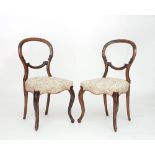 A pair of Victorian walnut balloon back dining chairs