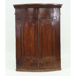 A Victorian mahogany bowfront hanging corner cupboard,