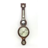 A mahogany wheel barometer with silvered dial,