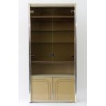 A modern cream laminate china cabinet fitted plate glass shelves,