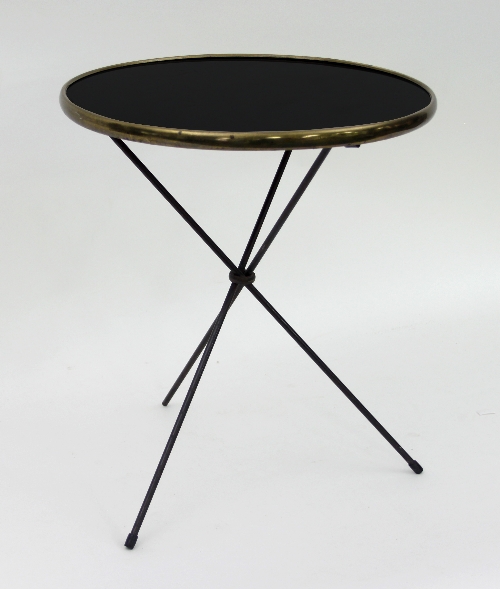 A French Art Deco style occasional table with circular black top within a brass rim on collapsible