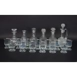A pair of cut glass decanters, three further decanters,