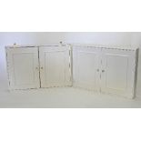 A pair of painted wall cabinets with panelled doors,