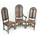 A set of eight beech armchairs of Carolean design, with twin arched caned backs and loose seats,