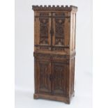 A French 19th Century gothic cupboard in two sections with castellated top,