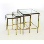 A nest of three brass and glass tables,