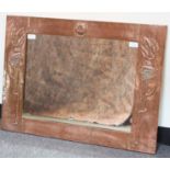 An Art Nouveau copper framed mirror, the frame with embossed stylised foliate decoration, 60.