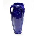 A large Continental blue glaze umbrella stand, in the style of Henry Van de Velde,