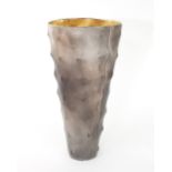 Joy Bosworth/A smoke-fired vessel of tall circular form with undulating and tapered body,