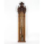 An Admiral Fitzroy barometer, the Victorian Gothic oak case with carved surmount and arch top,