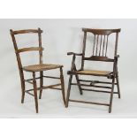 An Edwardian mahogany framed folding chair with cane seat together with another caned seat chair