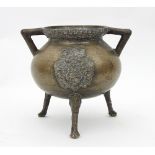 An Italian Renaissance style bronze cooking pot cast to one side with armorial and to the other