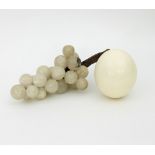 An ostrich egg and a bunch of alabaster grapes