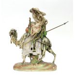 An early 20th Century Teplitz Amphora porcelain bisque figure of a desert rider on a camel,