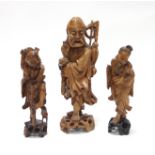 Three Chinese carved wood figures, each modelled standing,