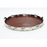 Murrle Bennett & Co/A white metal tray, with pierced gallery and twin handles, mahogany base,