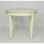A painted circular table, on fluted turned legs,