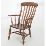 A Victorian beech and elm stick back armchair, with plain top rail,