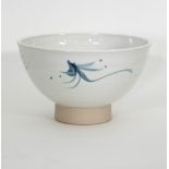 Russell Collins/A stoneware bowl in a white glaze with blue brush decoration, on a deep foot,